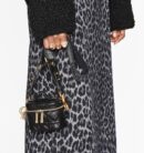 Model holding the Micro Lady Dior Vanity Case in black lambskin leather with gold-tone hardware