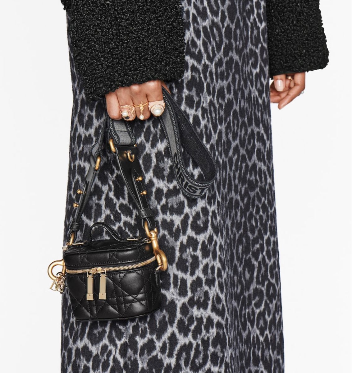 Model holding the Micro Lady Dior Vanity Case in black lambskin leather with gold-tone hardware