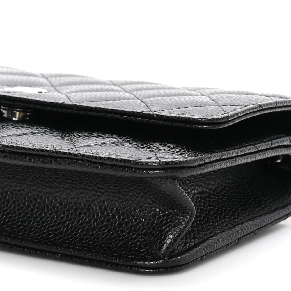 Side view of the black caviar leather Wallet On Chain showing the structured leather base