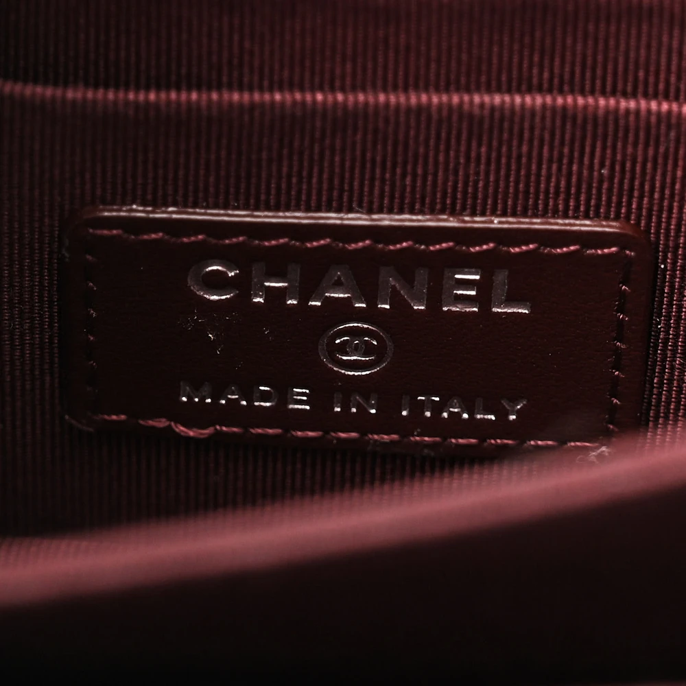 Close-up of the turn-lock closure and gold-tone hardware on the black caviar leather Mini Wallet On Chain