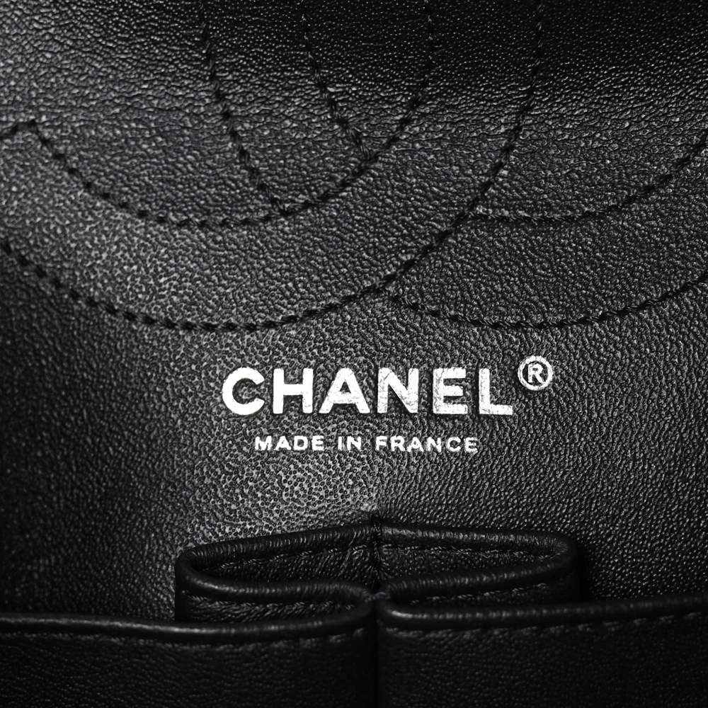 Close-up of the Mademoiselle turn-lock closure and aged silver-tone hardware on the Large 2.55 Reissue 226 flap bag
