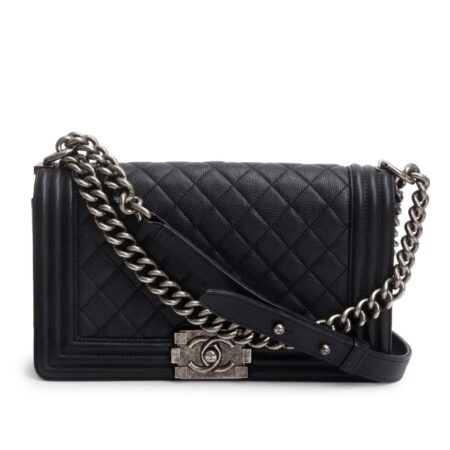 Front view of the black caviar leather Medium Boy Flap with signature Boy push-lock closure