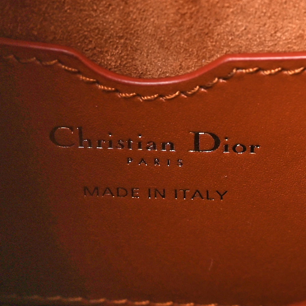 Close-up of the logo detail and gold-tone hardware on the camel box calfskin Medium Bobby Flap Bag