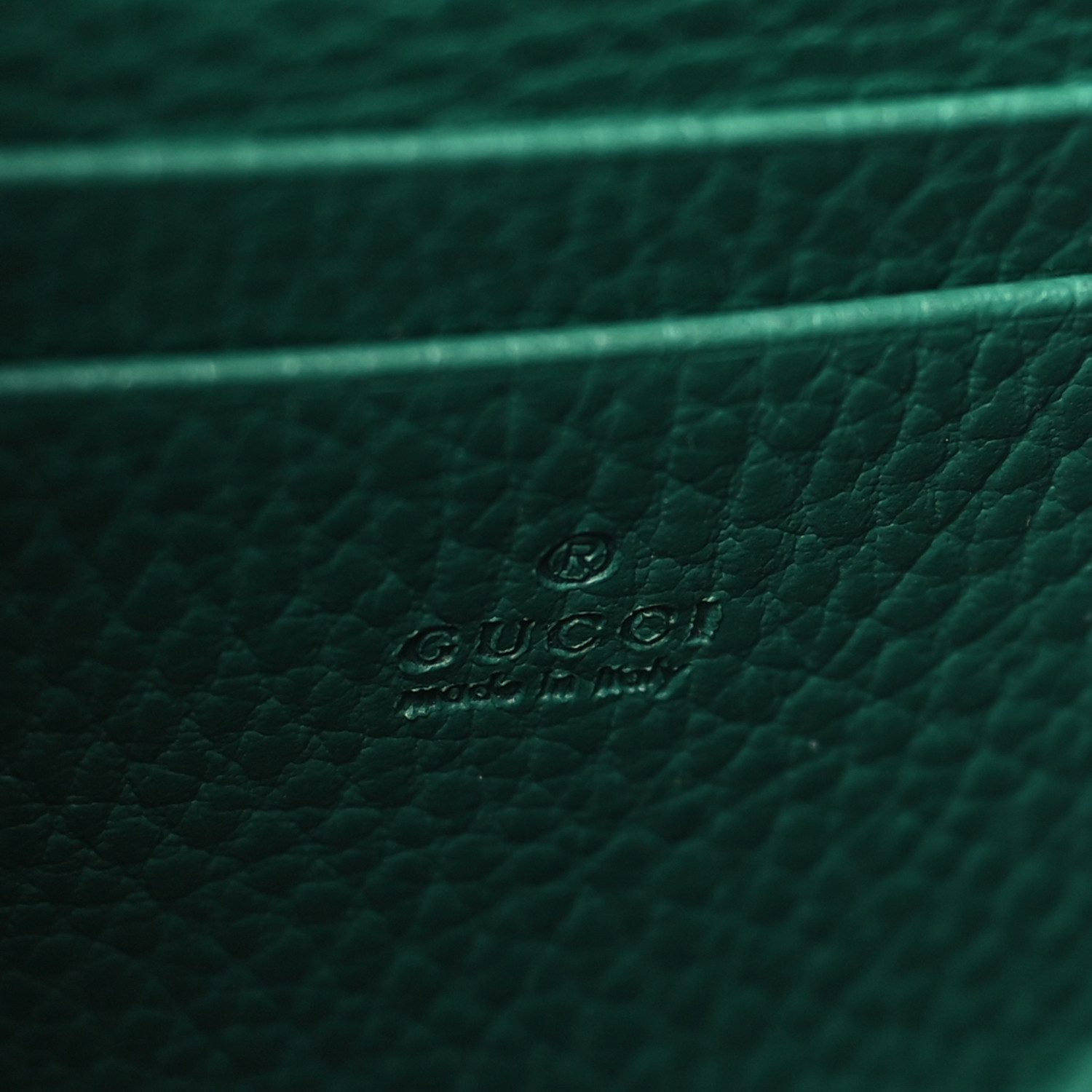 Close-up of the tiger head closure and antique silver-tone hardware on the emerald Mini Dionysus Chain Wallet