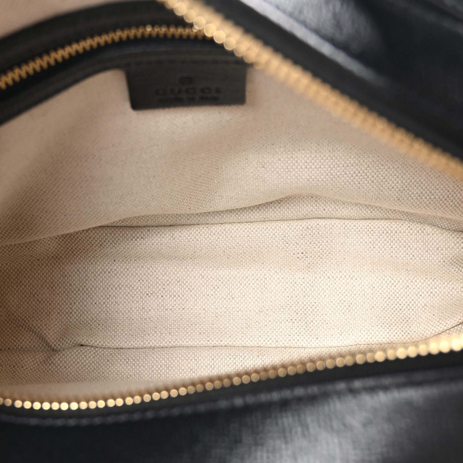 Interior view of the Small Horsebit 1955 Shoulder Bag with leather lining and organized storage compartments