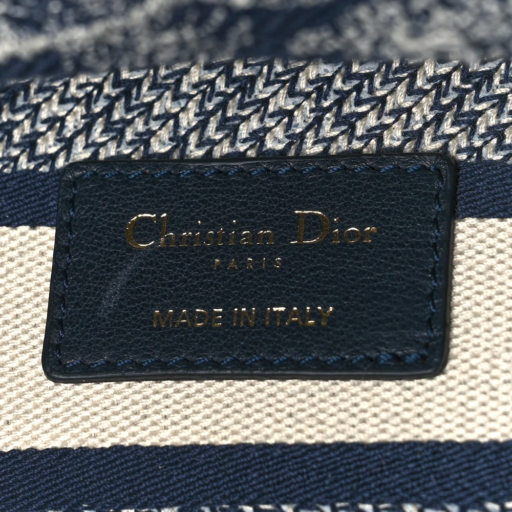 Close-up of the letter charms and gold-tone hardware on the blue Toile de Jouy embroidered Medium Lady D-Lite bag