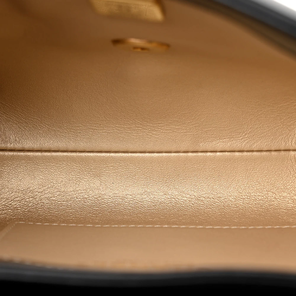 Interior view of the black lambskin CC Crystal Logo Chain Flap with leather lining and organized compartments