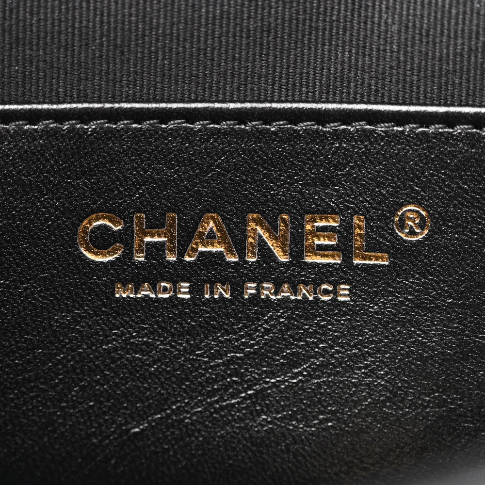 Close-up of the CC turn-lock closure and gold-tone hardware on the black lambskin Flap Clutch Bag