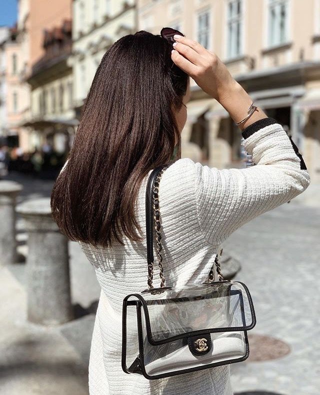 Model carrying the black PVC Ch@nel Sand By The Sea Flap with faux pearl shoulder strap