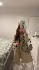 Model carrying the GG Supreme Mini Retro Interlocking G Half Moon Bag in Beige, Ebony, and Brown Sugar