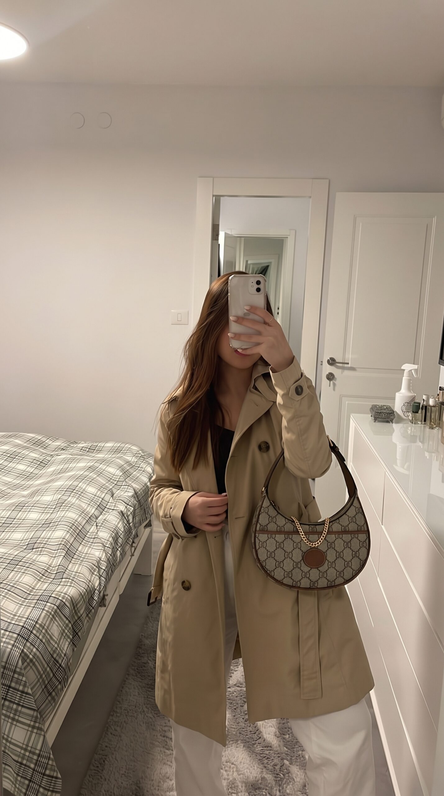 Model carrying the GG Supreme Mini Retro Interlocking G Half Moon Bag in Beige, Ebony, and Brown Sugar