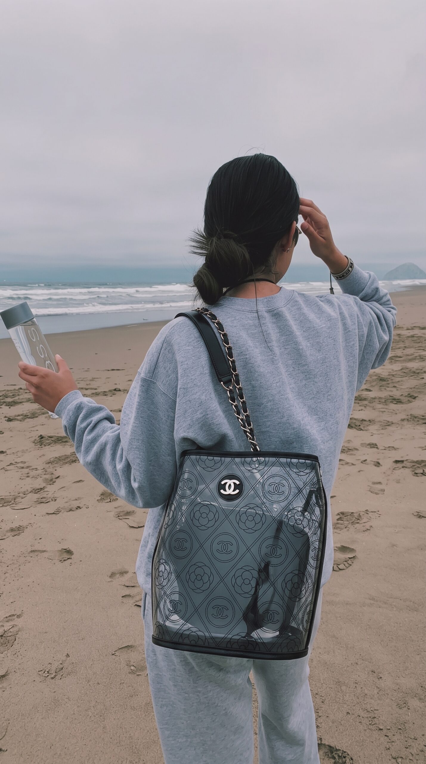 Model carrying the black crumpled calfskin and clear Ch@nel PVC Bucket Bag
