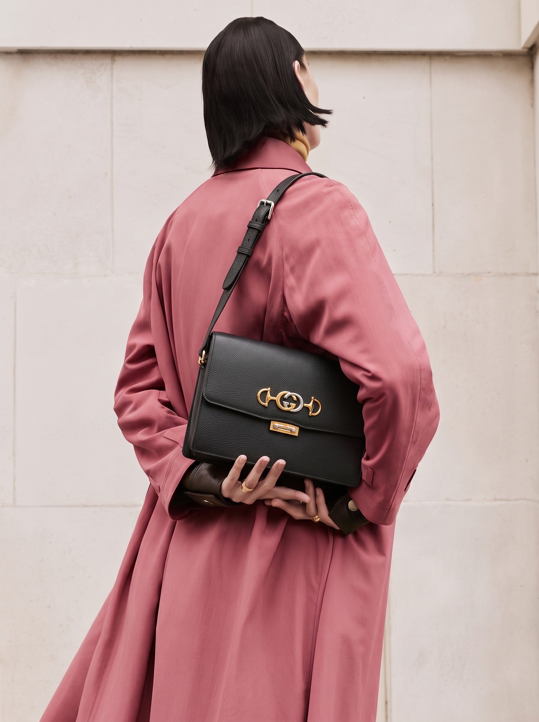 Model carrying a 1:1 replica Gucc! black grained calfskin Small Zumi shoulder bag with gold-tone hardware
