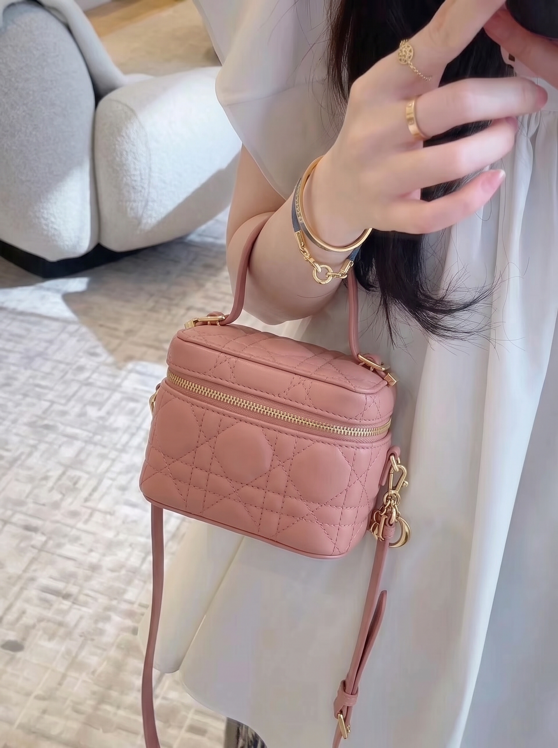 Model carrying a deep nude lambskin Micro Vanity Case with Cannage quilting