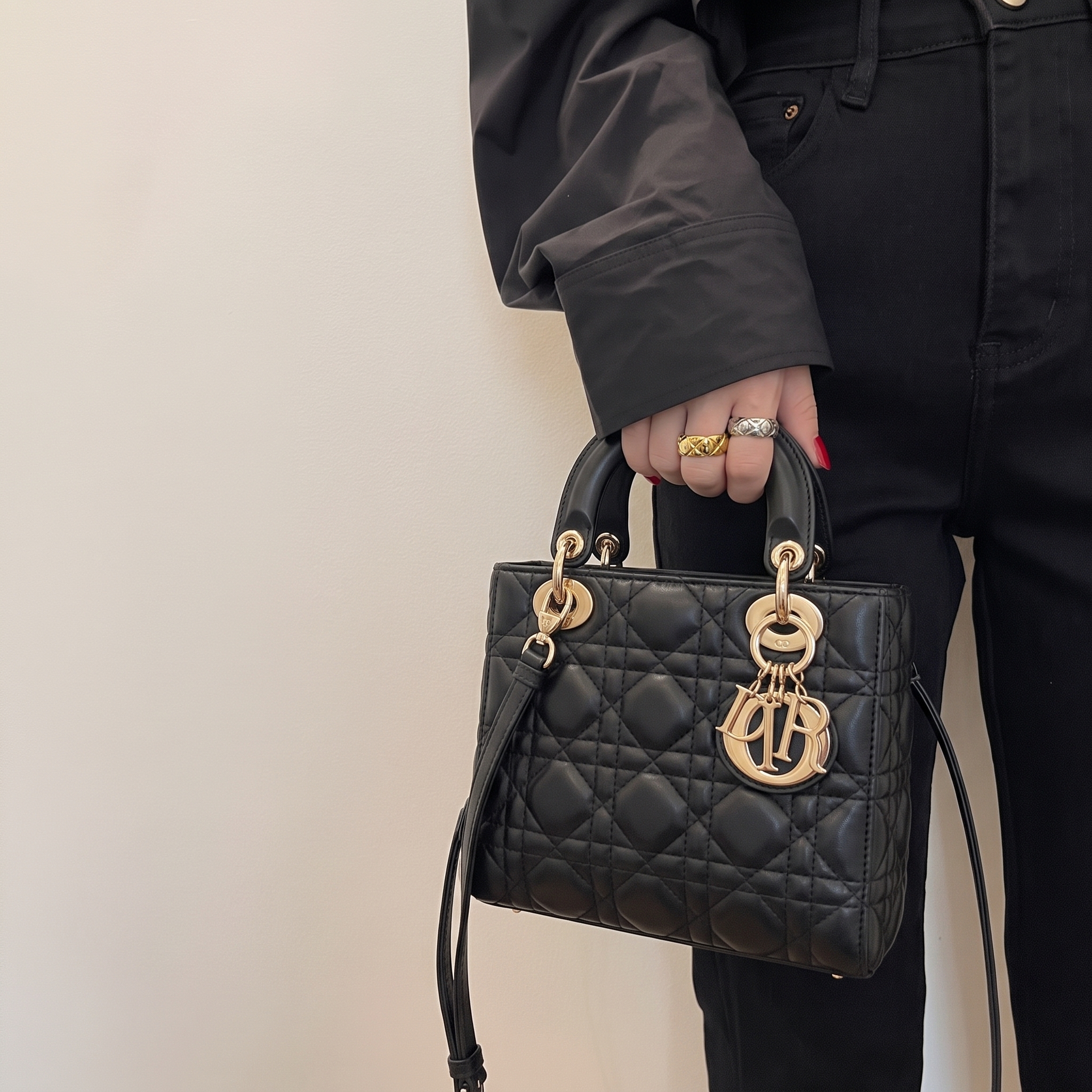 Model carrying a black lambskin Medium Lady bag with Cannage quilting and detachable shoulder strap