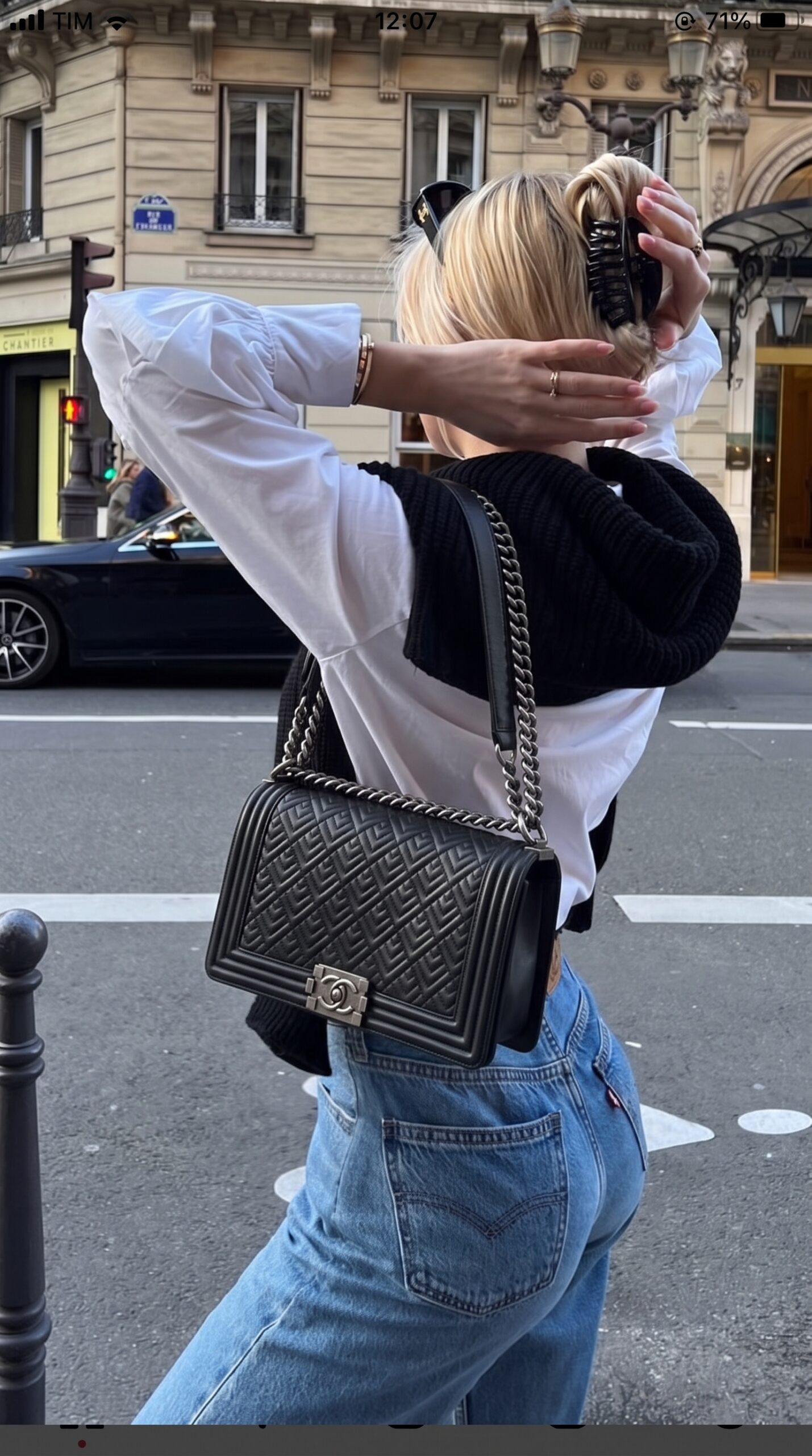 Model carrying the New Medium Boy Flap in black quilted lambskin leather with chain shoulder strap