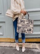 Model carrying the blue embroidered D!0r Medium Dioriviera Tote with rolled top handles