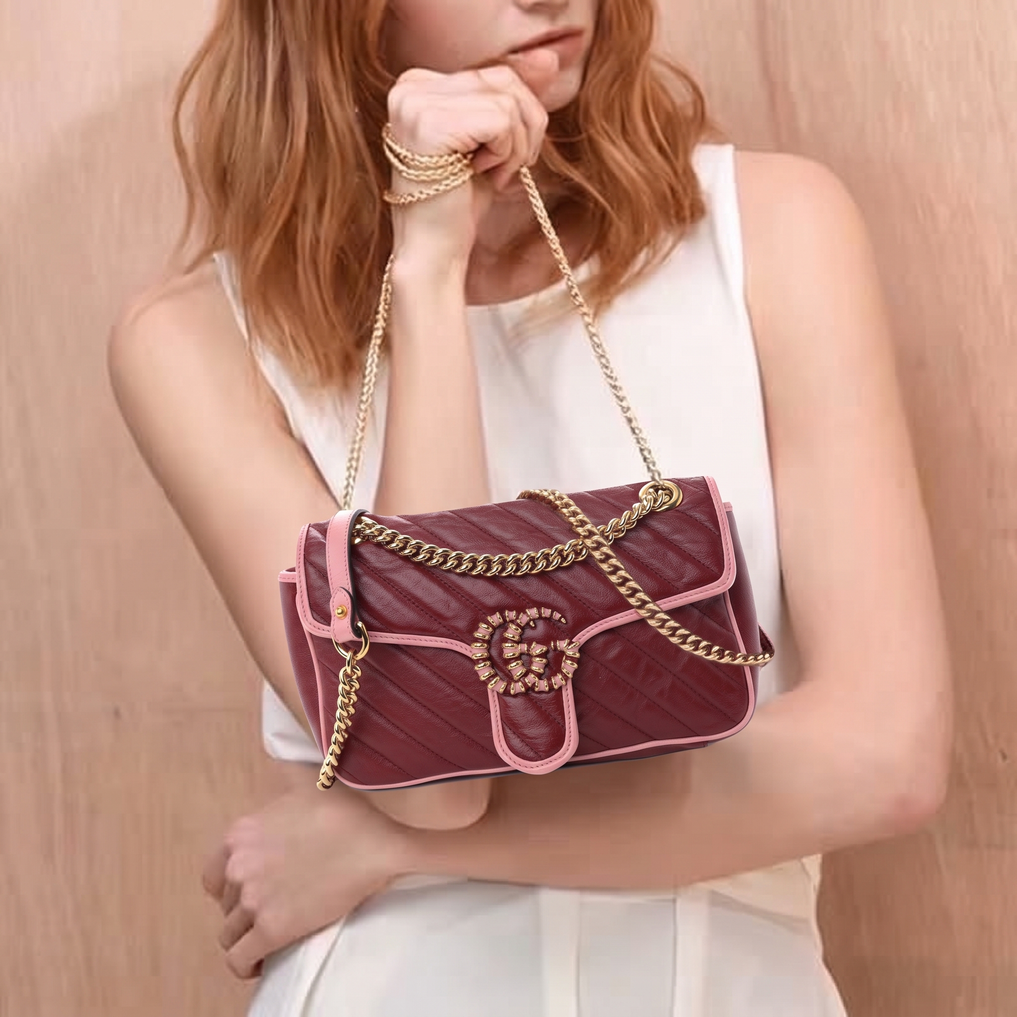 Model carrying the GG Marmont Small Torchon shoulder bag in New Cherry Red and Wild Rose