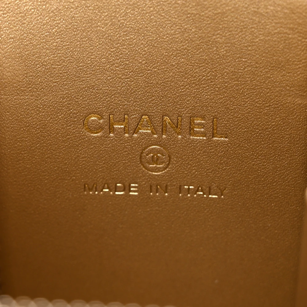 Close-up of the CC logo, Pearl Crush chain adjustment bead, and gold-tone hardware on the black lambskin Vanity Case